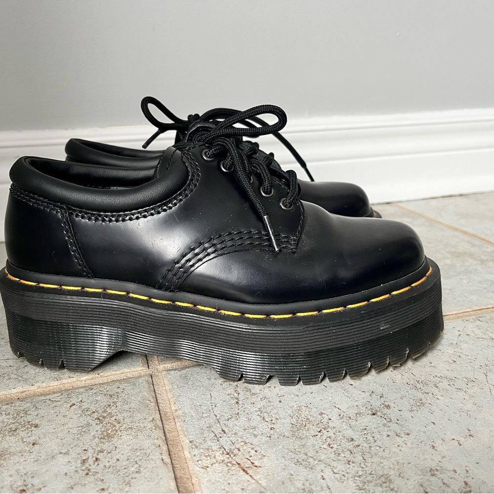 Doc Martens lace up platform shoes.